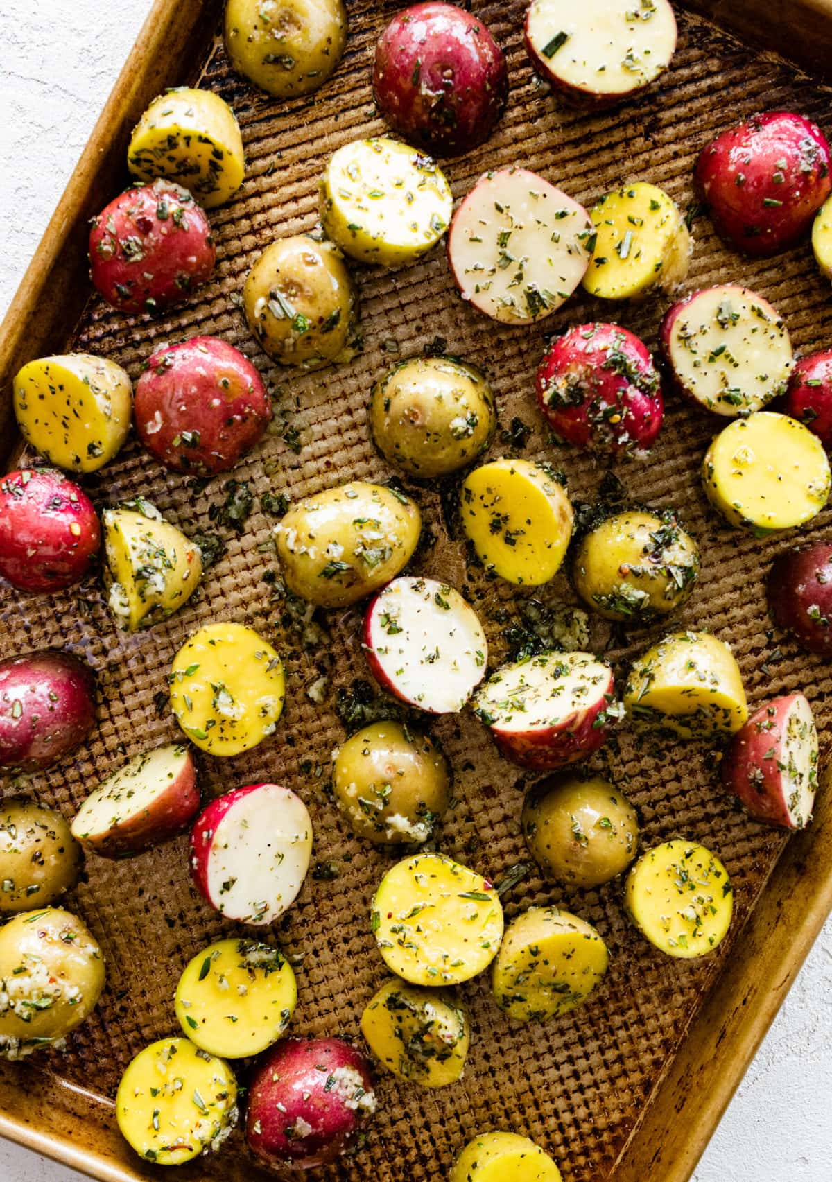 How to make crispy oven roasted potatoes step-by-step instructions: placing potatoes on a sheet pan.